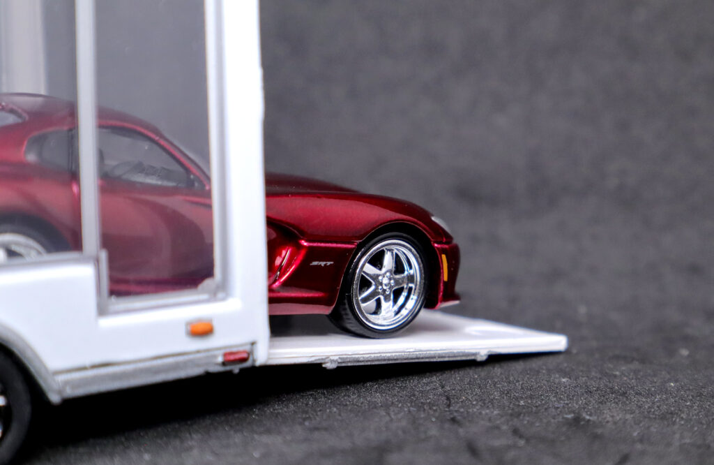 Closeup of Auto World 2014 Dodge Viper peaking out of Greenlight glass trailer
