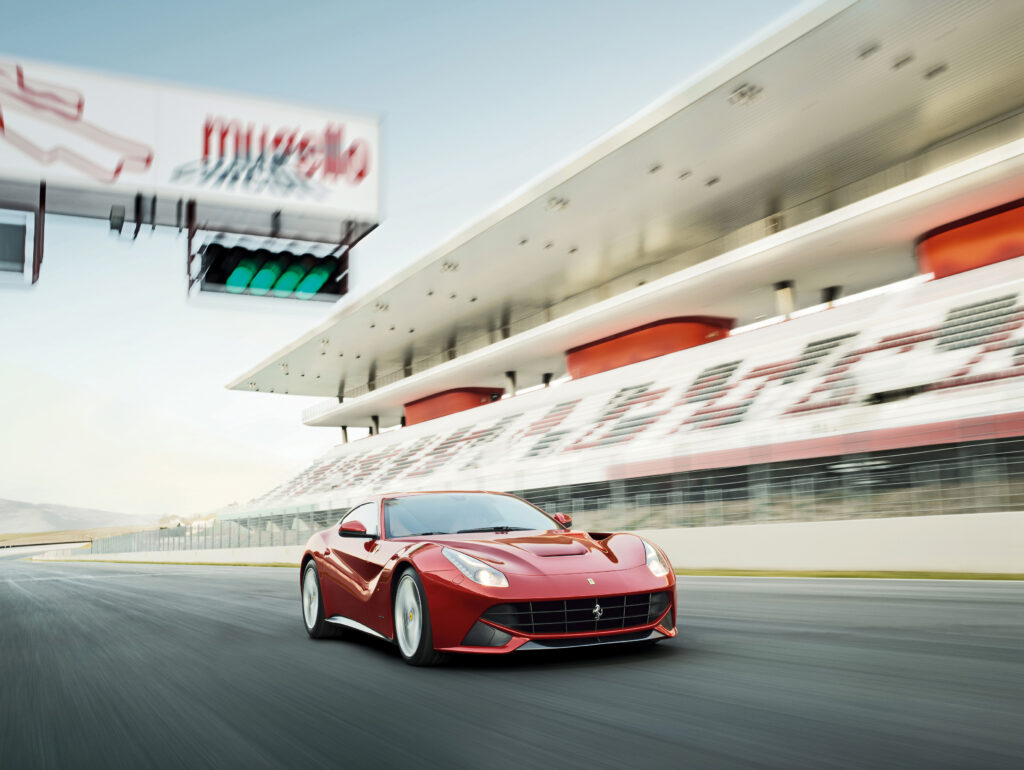 Red Ferrari F12 Berlinetta on a racetrack